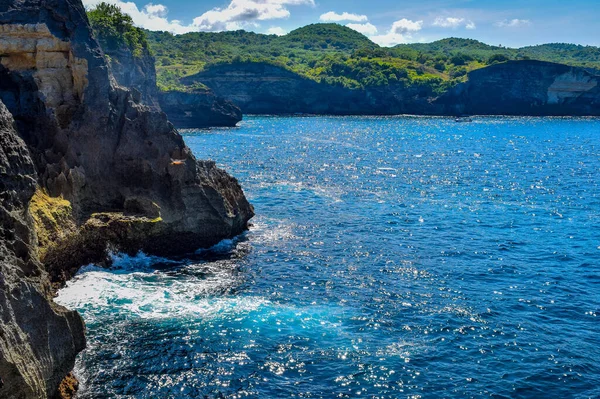 Beautiful Angel\'s Billabong view. Sharp dramatic rocks and crashing waves at the entrance to Angel\'s Billabong on Nusa Penida, wonderful Angels Billabong at Nusa Penida, Bali Indonesia, Angel\'s Billabong is natural infinity pool on the island