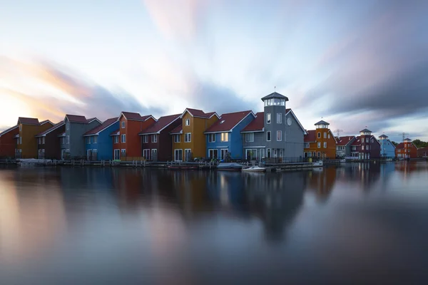 Holland Groningen - colorful houses with water reflection and evening dramatic sky