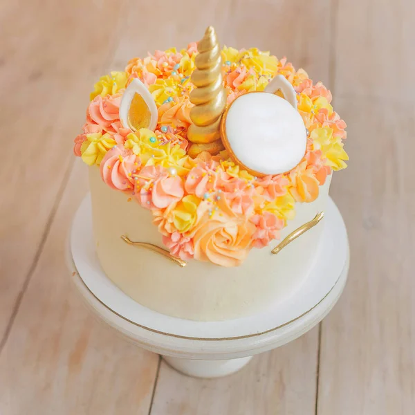 beautiful birthday unicorn cake on a white wooden background. View from above