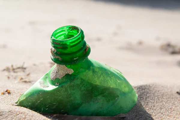 Plastic bottle in the sand, causing pollution at Poco beach, near the city of Joao Pessoa, Paraiba, Brazil on September 29, 2012