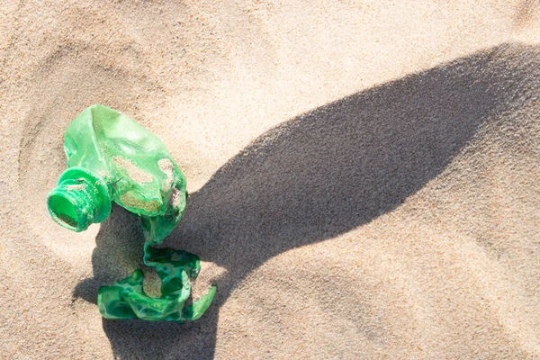 Plastic bottle in the sand, causing pollution at Poco beach, near the city of Joao Pessoa, Paraiba, Brazil on September 29, 2012