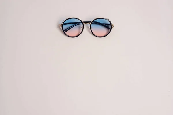 Solglasögon Beige Bakgrund Mitten Bakgrunden Ett Ämne För Stranden — Stockfoto