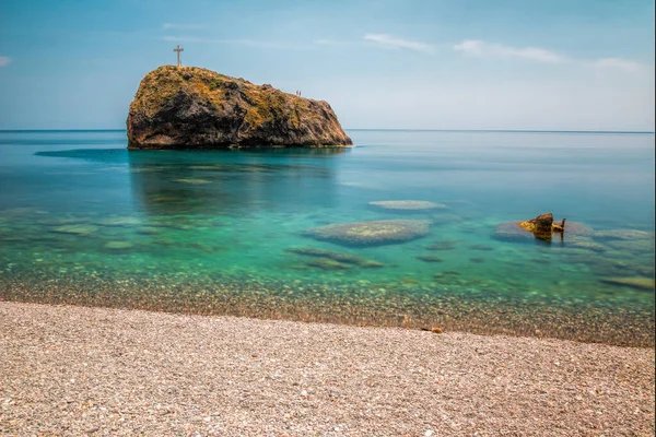 Long exposure photography. The blue sea and sky in sunny day. The beach is very clean with a rock of Holly fenomen on cape Fiolent. Copy space. The concept of calmness, silence and unity with nature