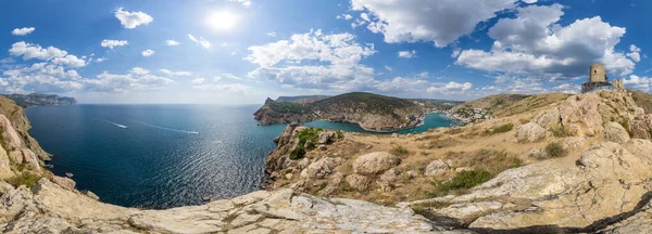 Scenic panoramic view of Balaclava bay with yachts from the ruines of Genoese fortress Chembalo. Balaklava, Sevastopol, Crimea. Inspirational travel landscape. Aerial photo. Copy space.