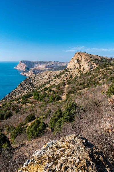 Scenic panoramic view of Balaclava bay with yachts from the ruines of Genoese fortress Chembalo. Balaklava, Sevastopol, Crimea. Inspirational travel landscape. Aerial photo. Copy space.