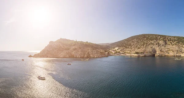 Scenic panoramic view of Balaclava bay with yachts from the ruines of Genoese fortress Chembalo. Balaklava, Sevastopol, Crimea. Inspirational travel landscape. Aerial photo. Copy space.