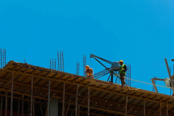 Mexican construction workers performing various tasks