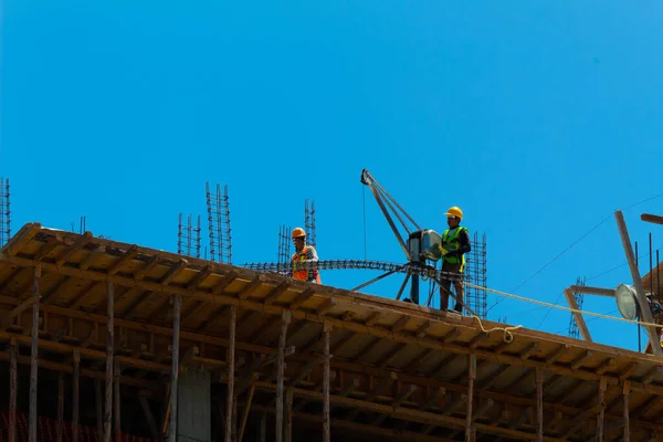 Mexican construction workers performing various tasks