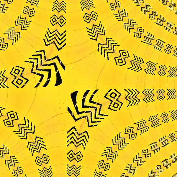 multiple black direction arrow and chevrons on vivid yellow textured painted wall diverse patterns and designs