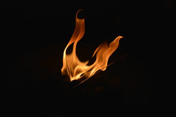 Яркое пламя в очаге на черном фоне — стоковое фото