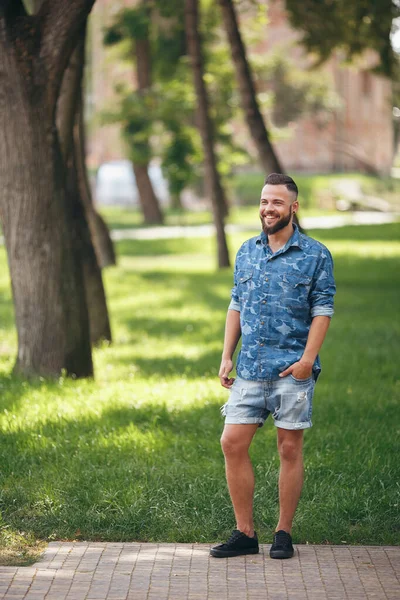 Young guy walking in the spring park. Sunny day. Vesna.Funny guy. A good mood. Walking portrait.