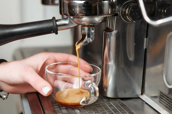 Professional coffee machine making espresso in a cafe