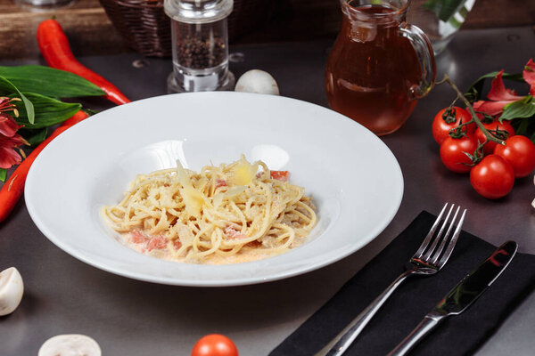 Plate of chicken pasta on a rustic wooden table.