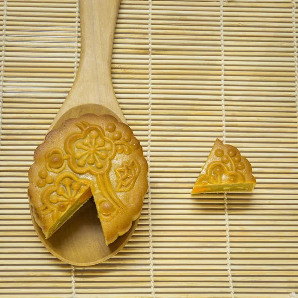 Mid-Autumn Festival moon cake in spoon on wooden traditional mat