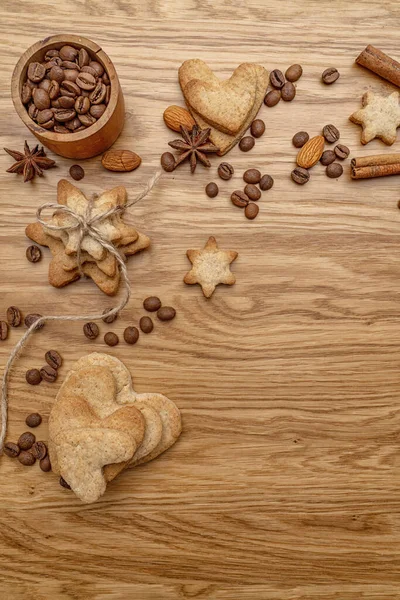 Background with homemade cakes, fragrant cookies. Cookies in the form of hearts, stars, coffee beans, spices, almonds close-up. menu concept, Home baking. Full size, cookiespeanuts