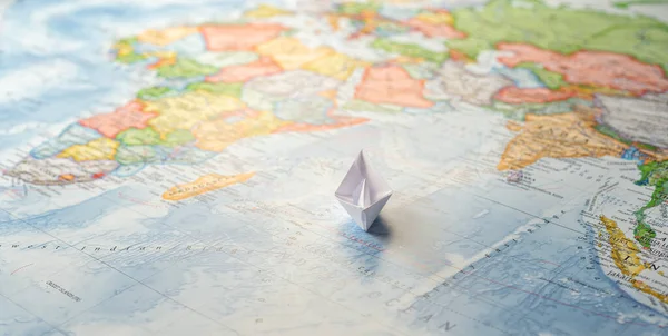 Paper boat sailing on the Indian Ocean towards the African coast