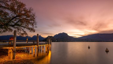 sunset in Annecy. Red clouds and a lake in the French Alps clipart