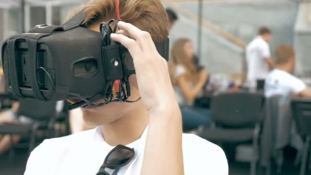 Man correcting VR glasses to pilot FPV drone — Stock Video