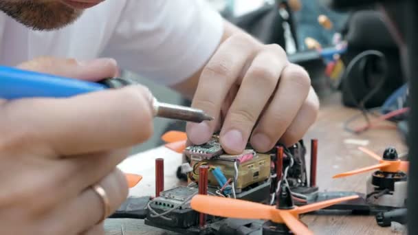 Mans hands welding details assembling FPV drone — Stock Video