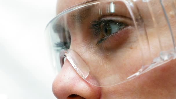 Doctor científico mirando los tubos de ensayo en el laboratorio — Vídeos de Stock