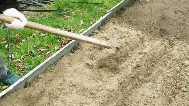 Country girl ploughs plows a bed vegetable garden — Stock Video