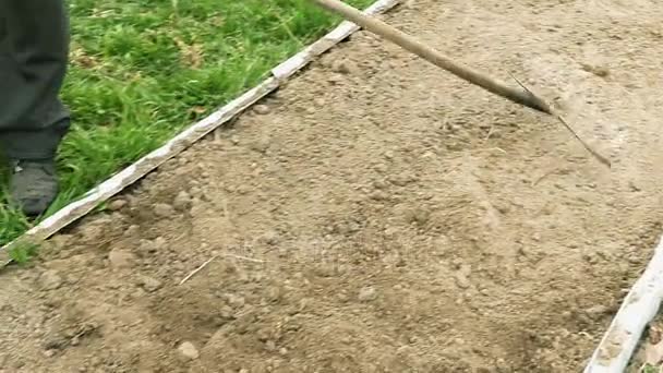 Senior elderly man ploughs plows vegetable garden — Stock Video
