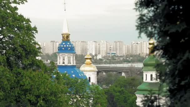 White blue and gold orthodox church in trees — Stock Video