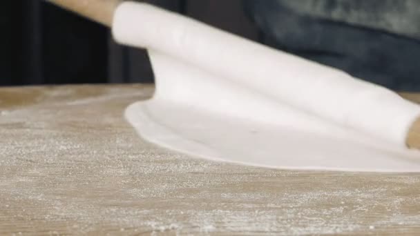 Rolling the pastry dough on a flat wooden surface — Stock Video