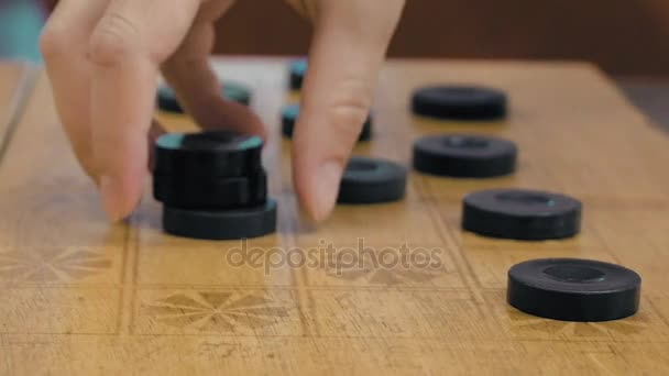 Close up of checkers on checkerboard on the table — Stock Video