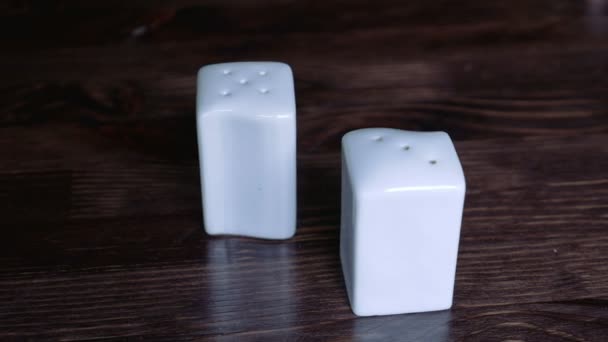 Pair of white salt and pepper pots — Stock Video