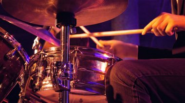Drummer plays on drum set and cymbal clipart