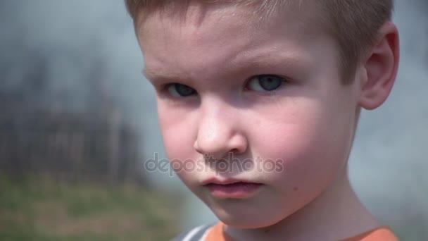 Sonriente niño contra las nubes de humo — Vídeos de Stock