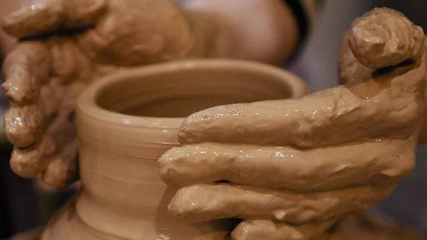 Поттер делает глиняный горшок на гончарном круге — стоковое фото