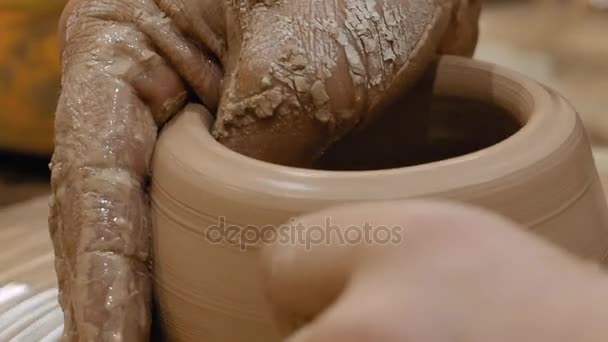 Potter is making clay pot on the potters wheel — Stock Video