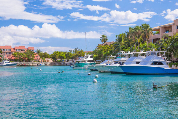 Harbor / marina in Puerto Aventuras with boats on a sunny day. The beautiful and popular coastal city in Riviera Maya, Mexico.