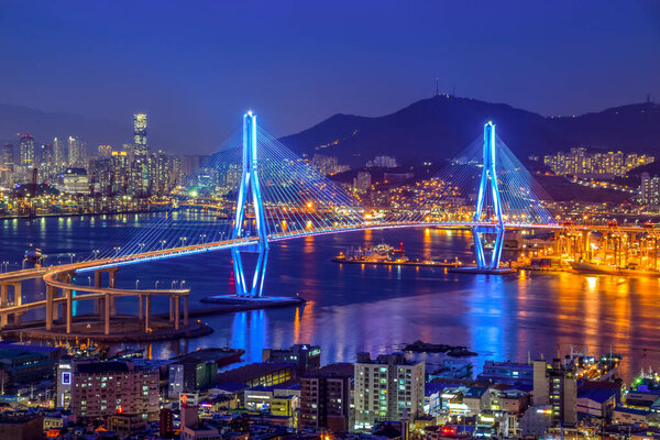 Busan harbor bridge lits up at night in different colors. Taken in Busan, South Korea