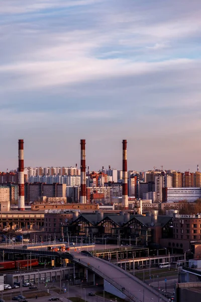 Urban industrial landscape in the evening at sunset. Beautiful blue sky, creative business buildings and residential buildings. Panoramic image from a height