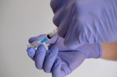 Beyaz arka planda bulunan korona salgınına karşı kovid-19 virüsü için el ele tutuşma şırıngası ve aşı