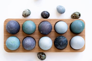 Ahşap tutacakta mavi ve siyah yumurtalar 