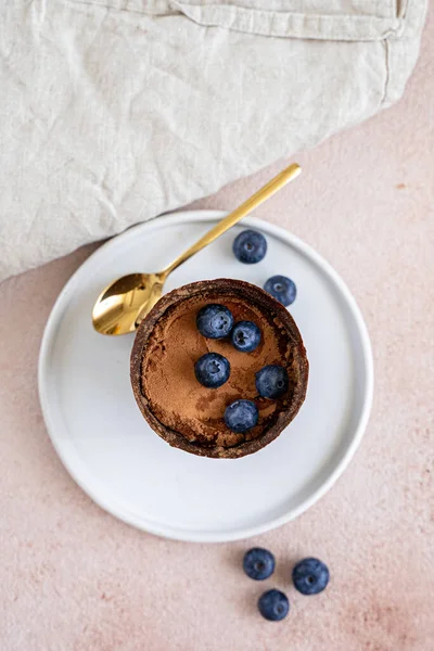 Tiramisu dessert in chocolate cup with berries