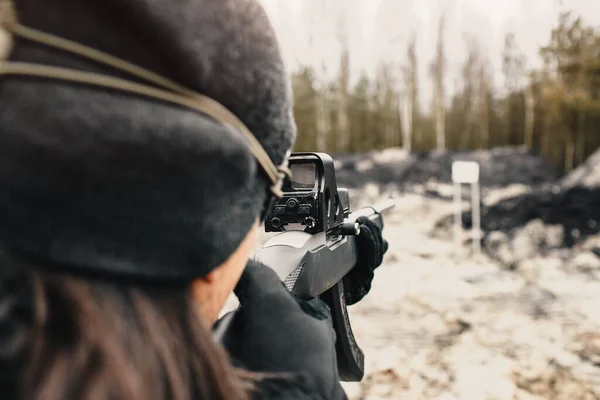 A guy shoots from a hunting rifle on the shooting range in the desert sport shooting. close up