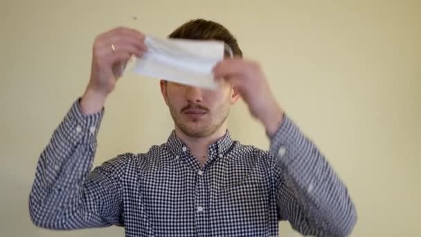 Hombre Lleva Máscara Contra Coronavirus Microbios Enfermedad Sobre Fondo Uniforme — Vídeo de stock