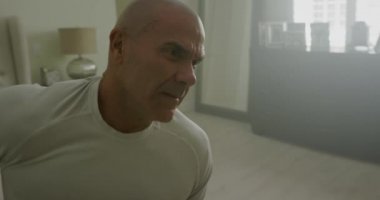 Adam uyanır ve yatak odasında gerinir.