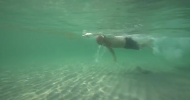 Man Swims Ocean Underwater — Stock Video