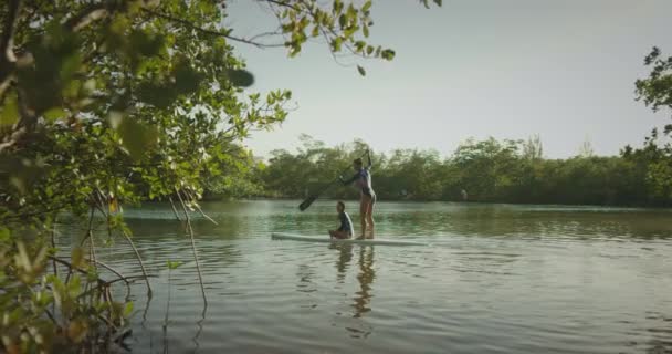 Mother Daughter Paddle Boarding Stock Video