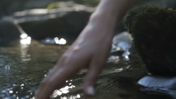 Girl hand caresses the lake water — Stock Video