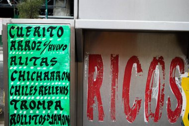 Mexico City 'de bir sokak yemeği standının menüsünde çeşitli yiyecekler var.
