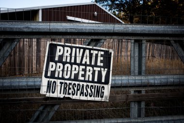 Sign on a fence that reads 