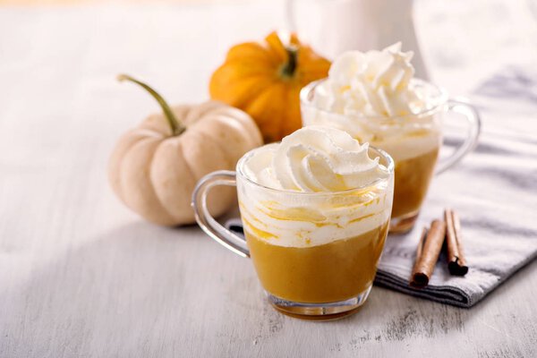 Pumpkin latte, hot caffee drink with pumpkins, whipped cream and