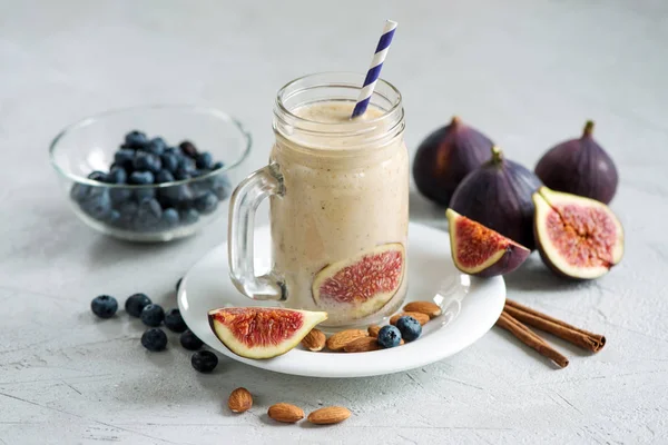Healthy smoothie with figs and nuts, vegan autumn drink with alm